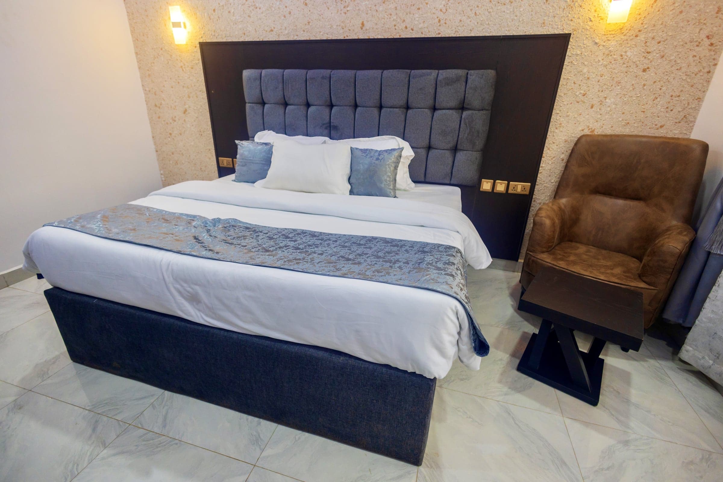 Deluxe Room at Diplomat Enclave Suites with a flat-screen TV and seating area