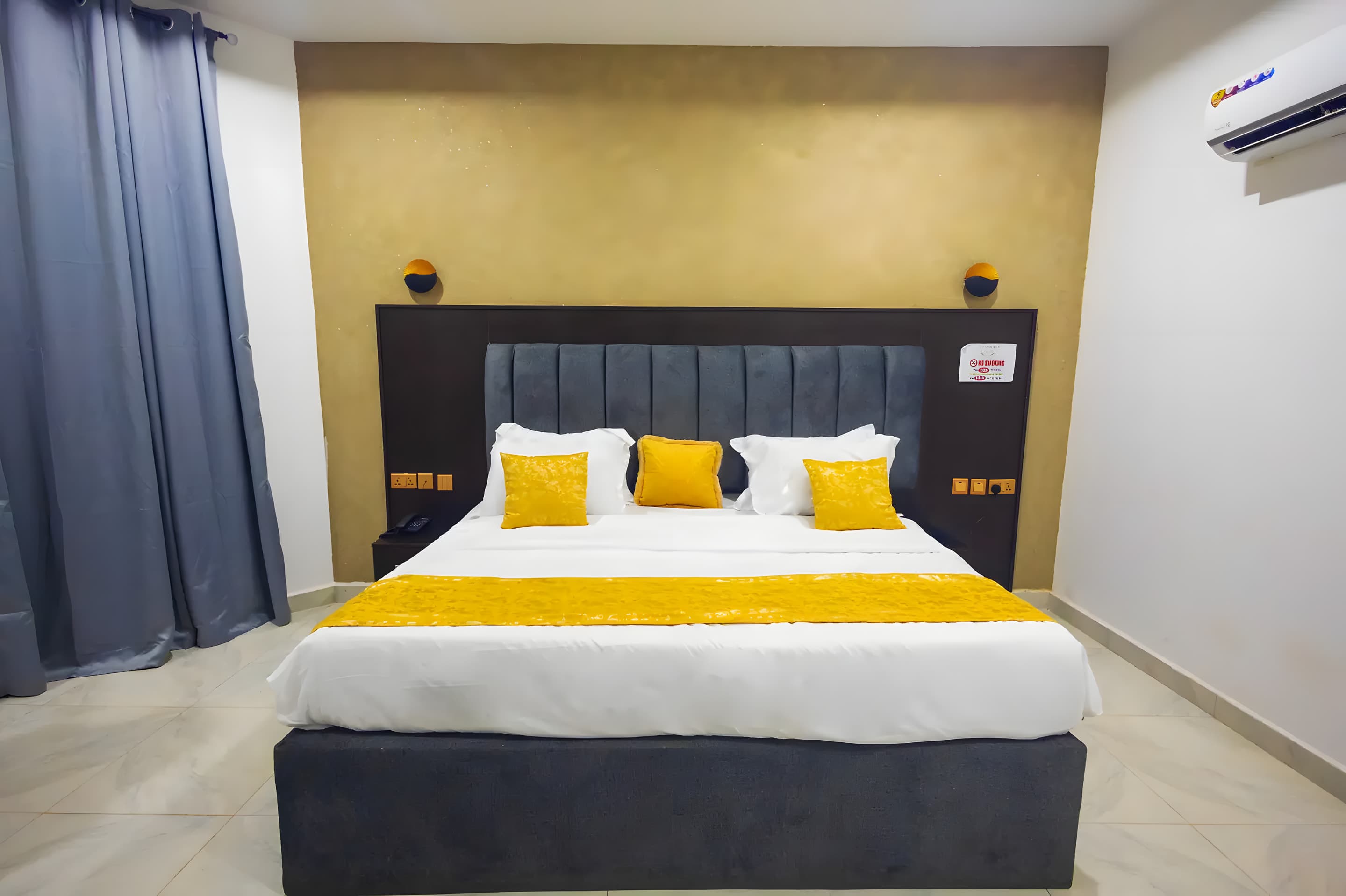 Deluxe Room at Diplomat Enclave Suites with premium bedding and soft lighting