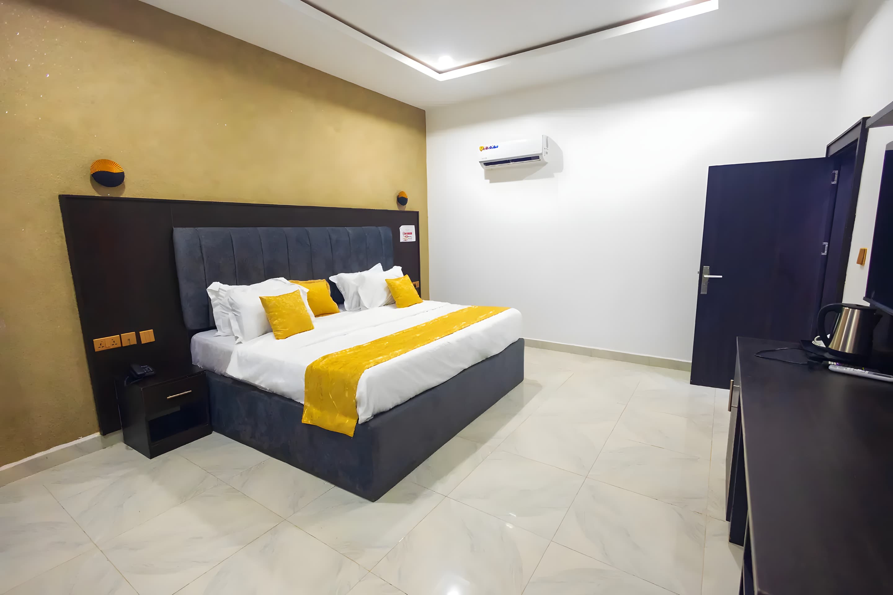 Deluxe Room at Diplomat Enclave Suites with a wardrobe and storage