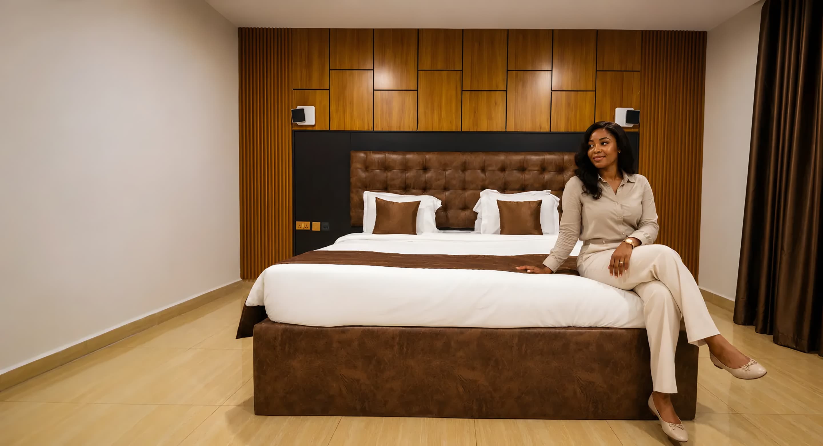 Guest relaxing on the bed in the Executive Room at Diplomat Enclave Suites