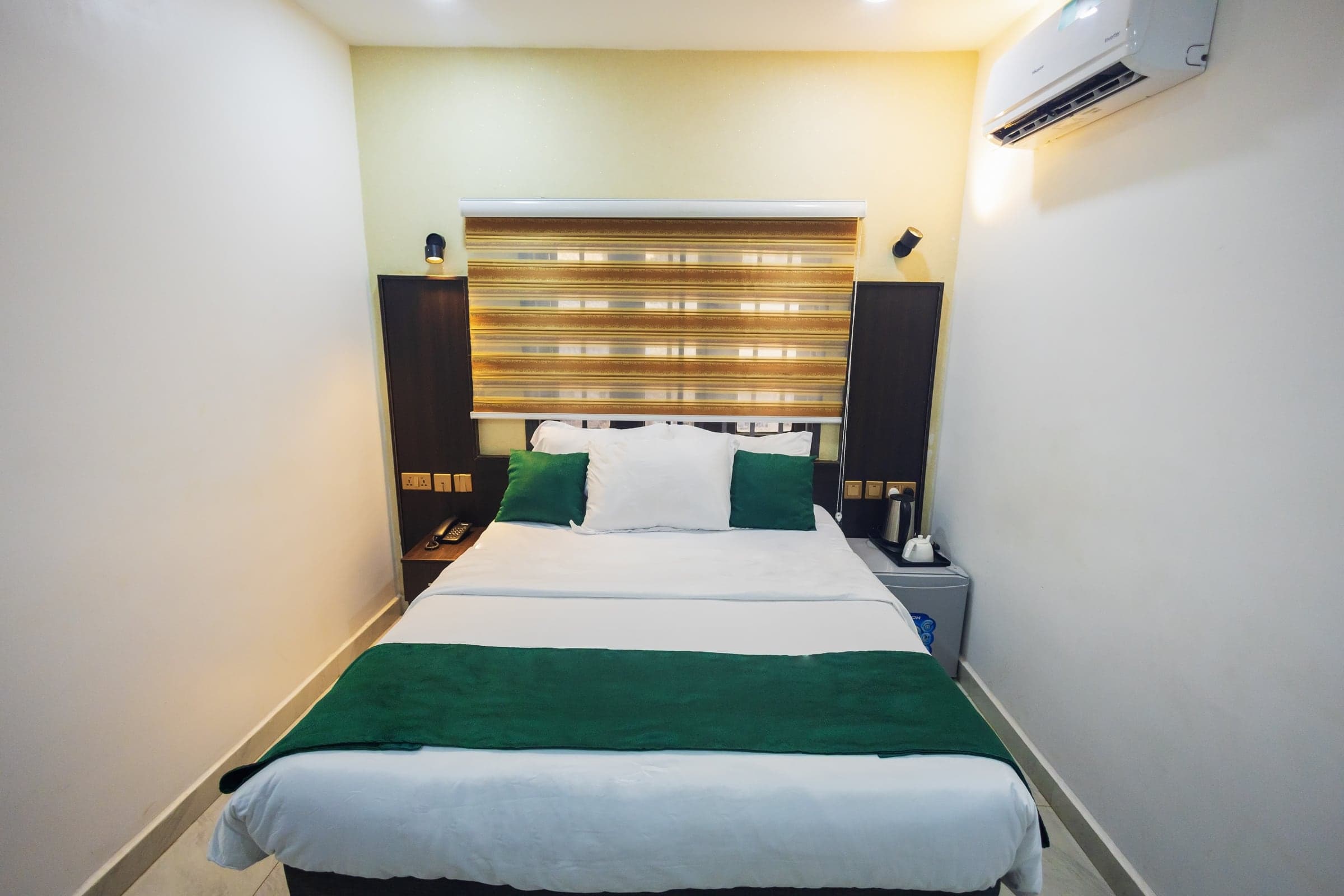 Standard Room at Diplomat Enclave Suites with a comfortable queen bed and natural light