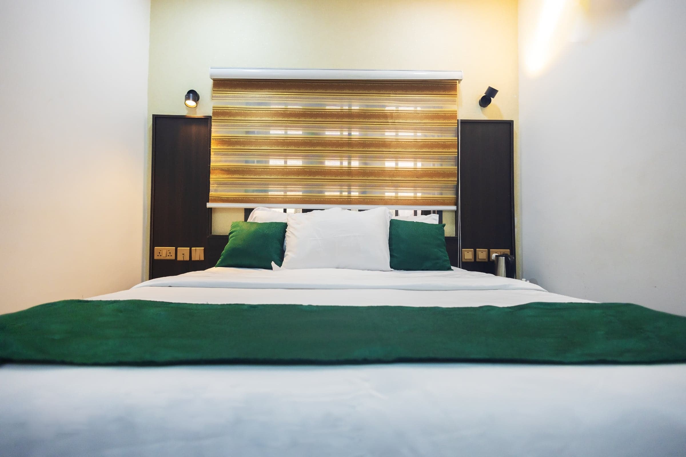 Standard Room at Diplomat Enclave Suites with a queen bed and work desk