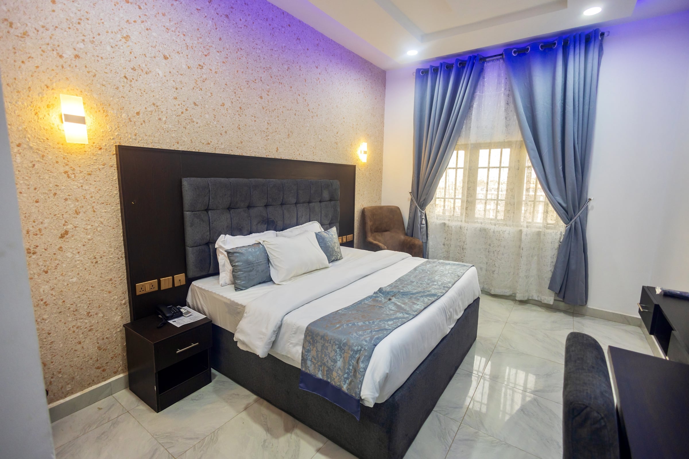 Deluxe Room at Diplomat Enclave Suites with a king bed and premium bedding